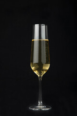Champagne glasses on a black background.Alcoholic beverages.