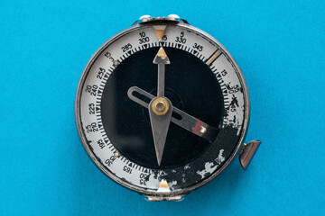 Old soviet compass close-up on a blue background top view isolated