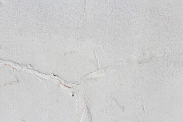 Close up of textured racked white old wall background. Copy space option