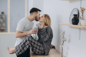 Young couple having a romantic breakfast at home in the kitchen