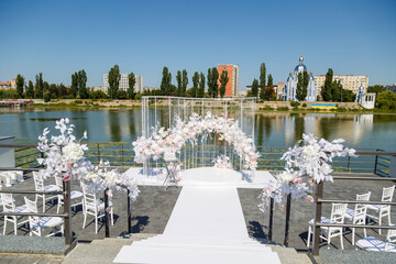 Festive arch for the ceremony of painting the newlyweds on the wedding day, wedding decor with fresh flowers