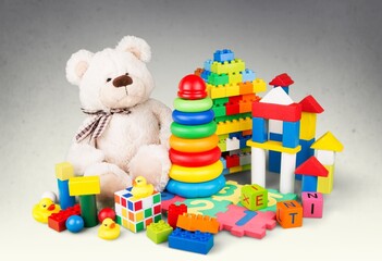 Baby kids toys on background. Soft bear and many colorful educational wooden, plastic toys.