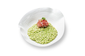 Risotto arborio rice with salmon and spinach in a plate on a white isolated background