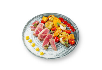 Salad with tuna and vegetables, mango, leeks and grilled tomatoes with sauce on a white isolated background