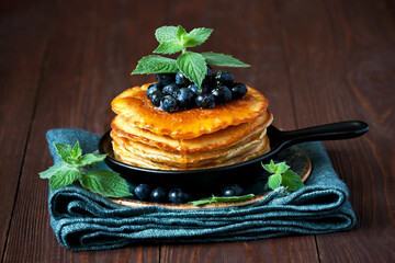 Dessert plate with pancakes, blueberry and  honey  syrup