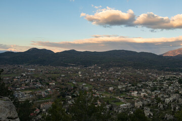 Abandoned ghost town. Top view of old city with historical structures. White clouds on sky. Fethiye Kayaköy, Turkey.	