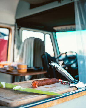 Traditional Spanish sausage chorizo on cutting board in camper van