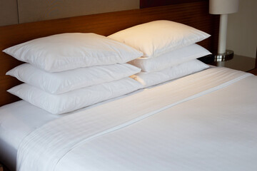 Bed with pillows in bedroom hotel