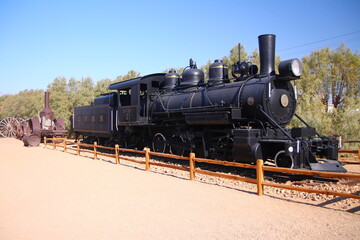 The traditional black locomotive of the gold rush in the Death Valley desert