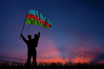 Father and son hold the flag of Azerbaijan
