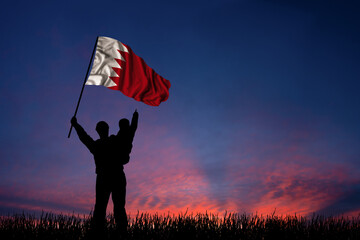 Father and son hold the flag of Bahrain