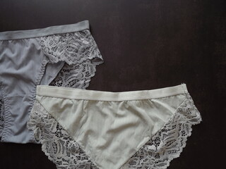 A pair of women's guipure panties on a black background. High quality photo