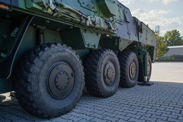 Large military grade tires on green gray army vehicle, closeup detail