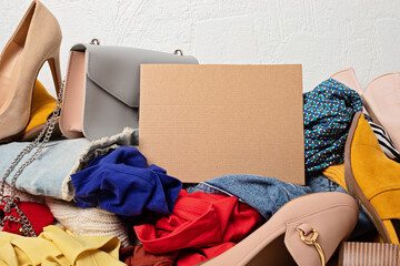 Fast fashion background with pile of cheap, low quality clothes. Garment made in unjust, inhumane...