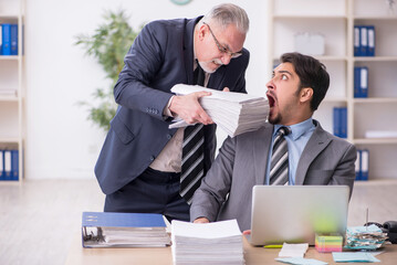 Two male employees in bullying concept