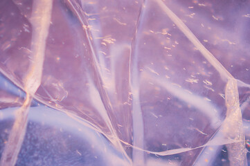 Fragment of an ice figure in the rays of the sun. Natural texture. Refraction, reflection and...