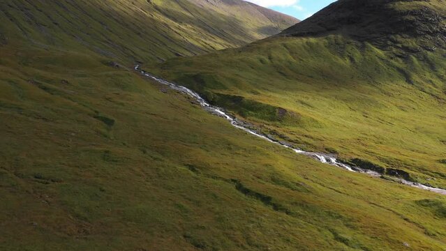 Aerial view of river and waterfall in the highlands in Scotland