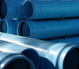 Full frame close-up view of stacked blue large main water pipes
