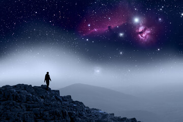 Human Silhouette walking on top of mountain, galaxy sky. Astronomy  - obrazy, fototapety, plakaty