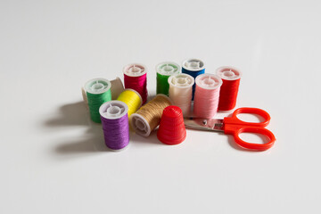 Set of different sewing threads on white background