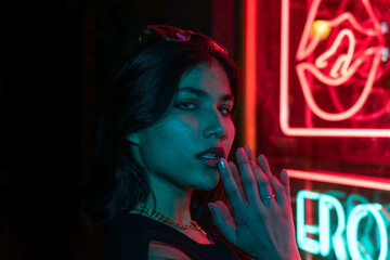 Cinematic night portrait of girl and neon lights
