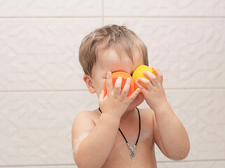 happy little boy bathes in the bathtub. Close-up. Soft focus. The concept of child care.