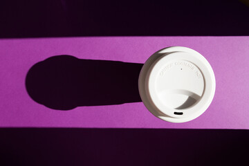 Reusable cup made from recycled cardboard with lettering Caution content hot. Reduce takeaway coffee cup waste