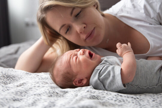 mother looks at crying baby