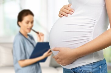 Preparing for baby birth. Woman expecting baby having appointments with doctor at antenatal clinic prenatal healthcare center.