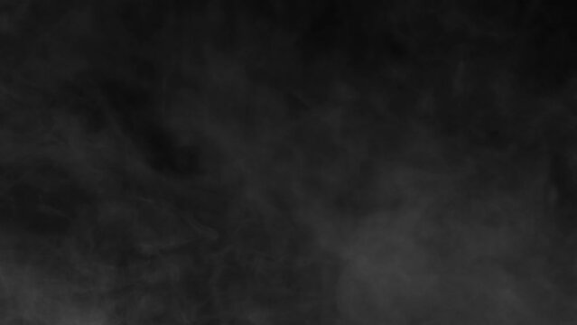 Abstract white smoke in slow motion. Smoke, Cloud of cold fog in light spot background. Light, white, fog, cloud, black background, 4k, ice smoke cloud. Floating fog.	