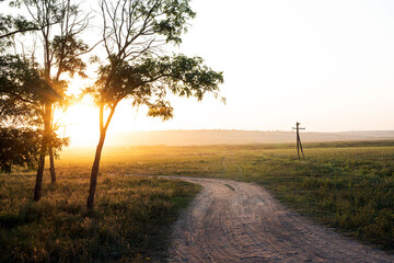 Beautiful sunset on the green hills in the countryside