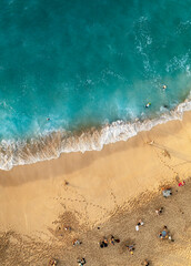 Perfect beach with people tanning and swimming in turquoise ocean , aerial shot from above