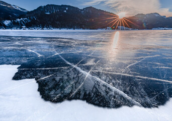 sunset over a frozen lake in winter 