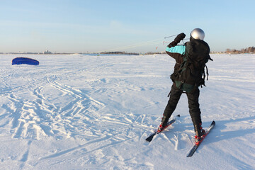 Man raising kite on the snow, Ob reservoir, Novosibirsk, Russia