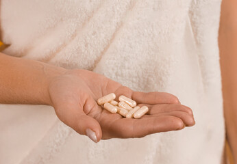 pills in a female hand close up