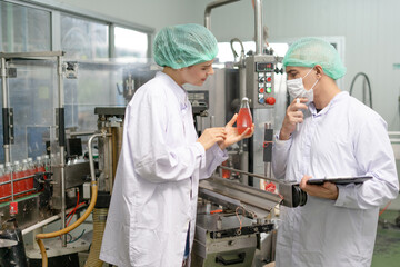 A quality supervisor or a food or pharmaceutical technician inspects the quality of food and drugs before sending the product to the customer. Employees are in an industrial water containment chamber.
