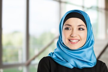 beautiful woman in hijab smiling on outdoor background