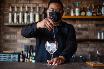 Bartender preparing a cocktail at the bar