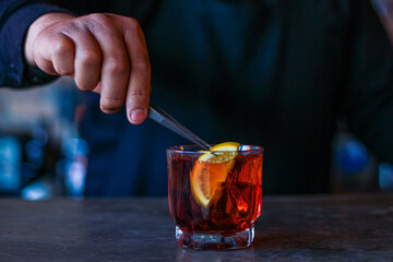 Hand of bartender preparing a cocktail at the bar