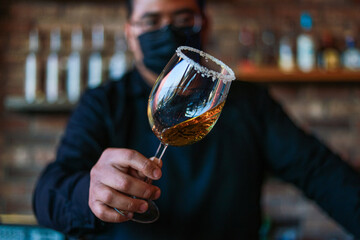 Bartender preparing a drink on a glass
