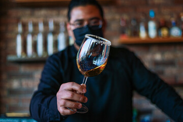 Bartender preparing a drink on a glass