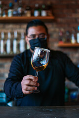 Bartender preparing a drink on a glass