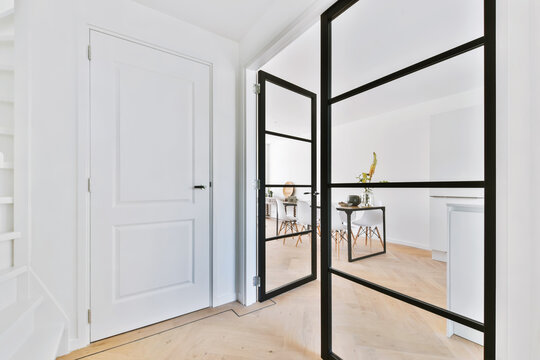 Stylish corridor with a large glass door with a black frame