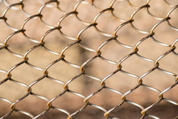 Mesh rabitz , texture of weaving mesh network link. Close up of a fence. barrier on way. metal grid close-up. rusty mesh texture