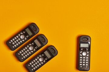 Antique home phone on yellow background.
