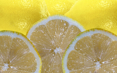 cut slices of lemons fresh and whole lemons in the back