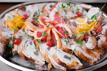 Meat plate decorated with herbs, grapefruit and oranges