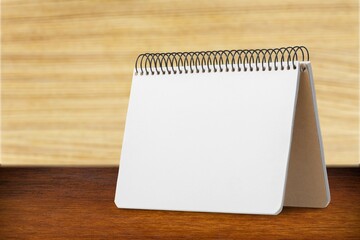 The blank calendar 2022 on wooden background.