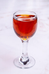 Transparent brown liquid in a glass
