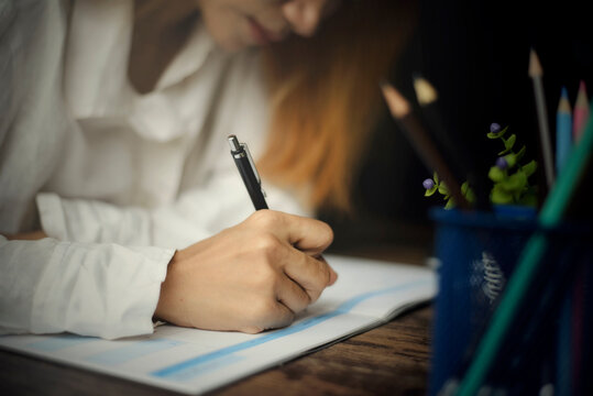 Planner plan Schedule Calendar and reminder agenda, work online at home. Women hand writing daily appointment and note holiday trip in diary at business office desk. Calendar reminder event concept.